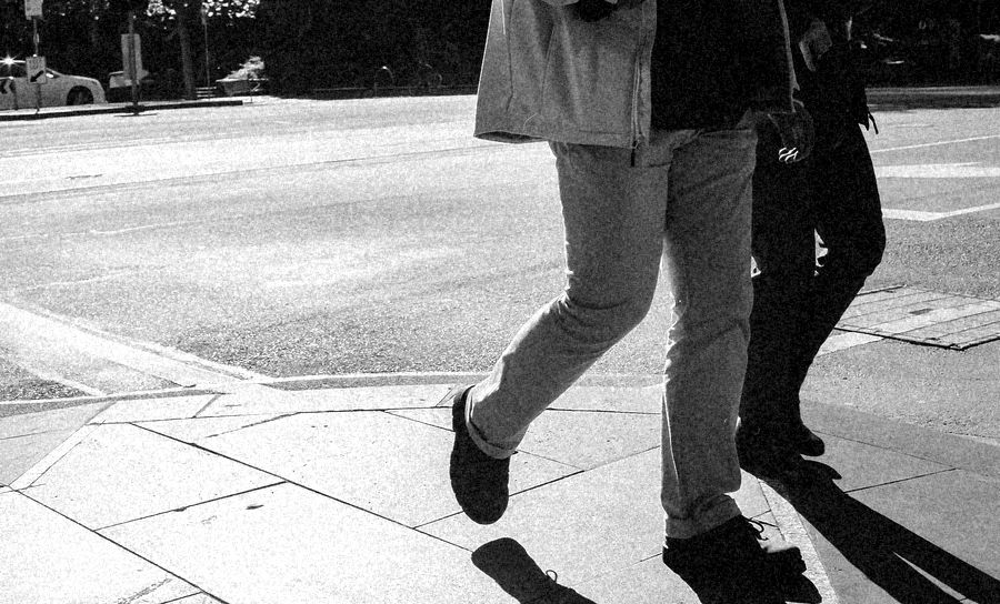 Feet crossing a street