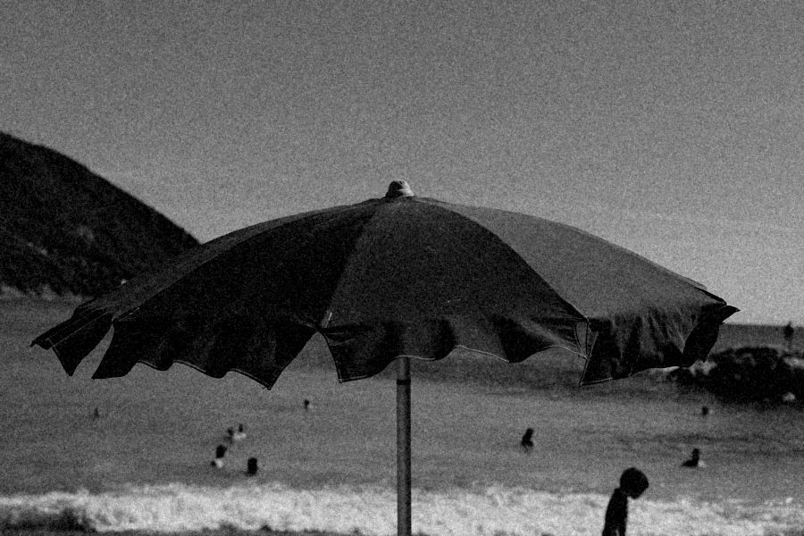 Beach umbrella against a hillside