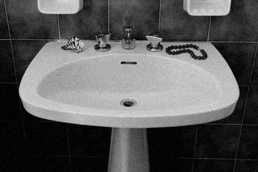 Pedestal sink against tiles