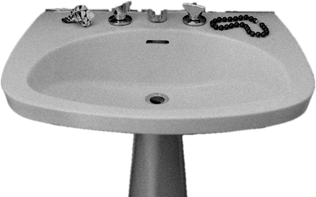 A pedestal sink with a shell and red beads, cut out