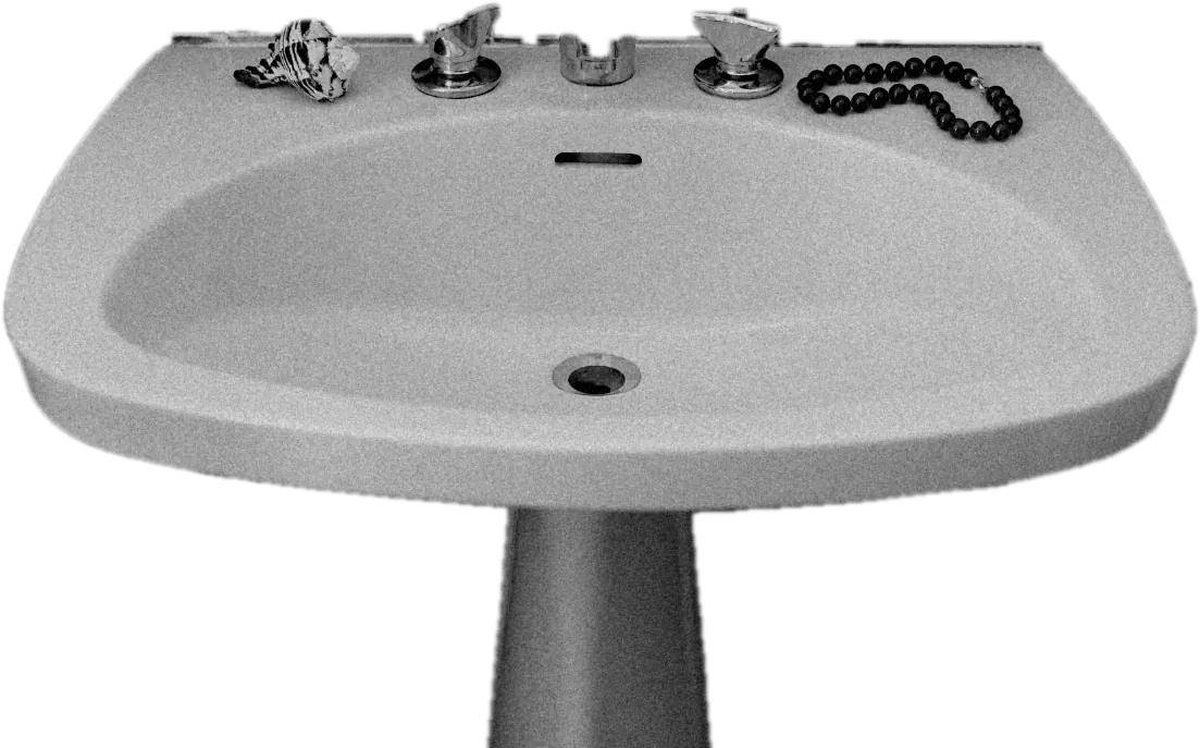 A pedestal sink with a shell and red beads, cut out