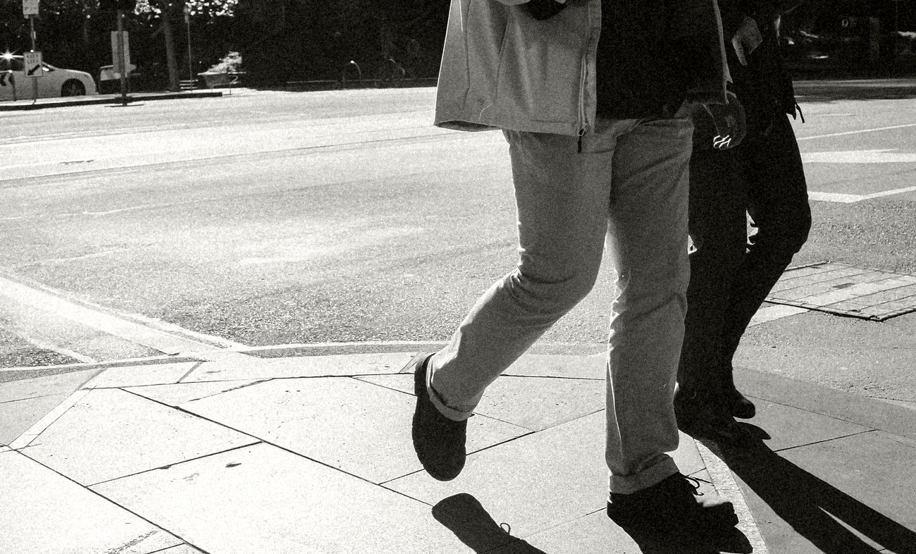 Feet crossing a street